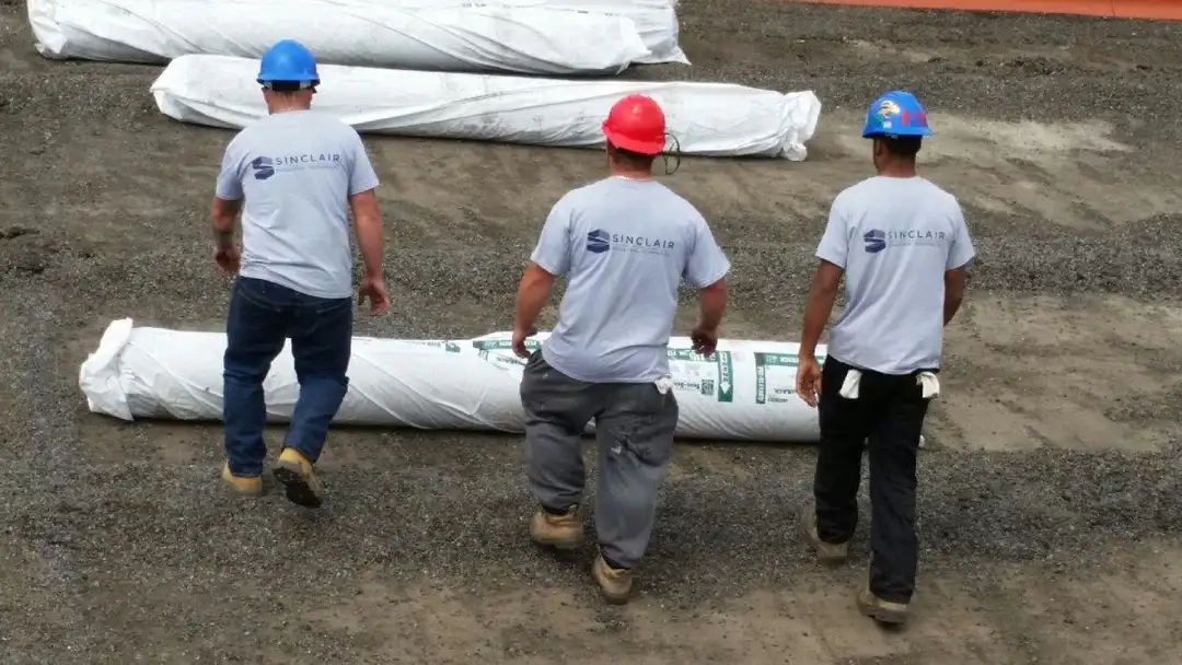 Sinclair Industrial Roofing crew installing a new commercial roof membrane